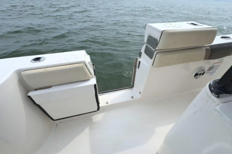 Slide: The Image of 2019 Robalo R272 Center Console boat with open transom door on the water. - 13