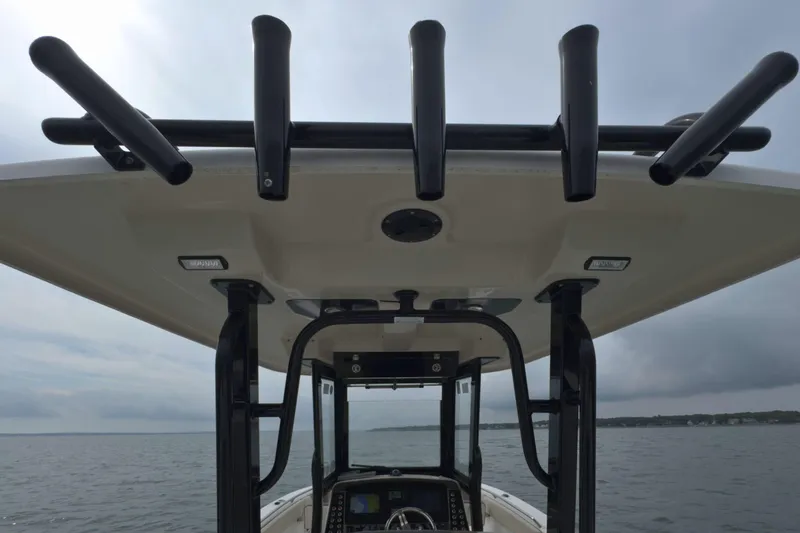 Slide: The Image of 2019 Robalo R272 Center Console boat with rod holders on the roof. - 15