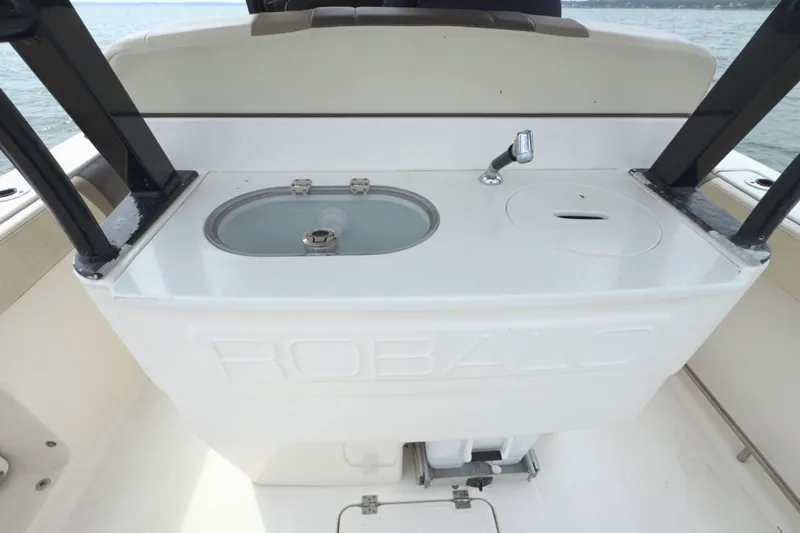 Slide: The Image of 2019 Robalo R272 Center Console boat sink and storage area. - 16