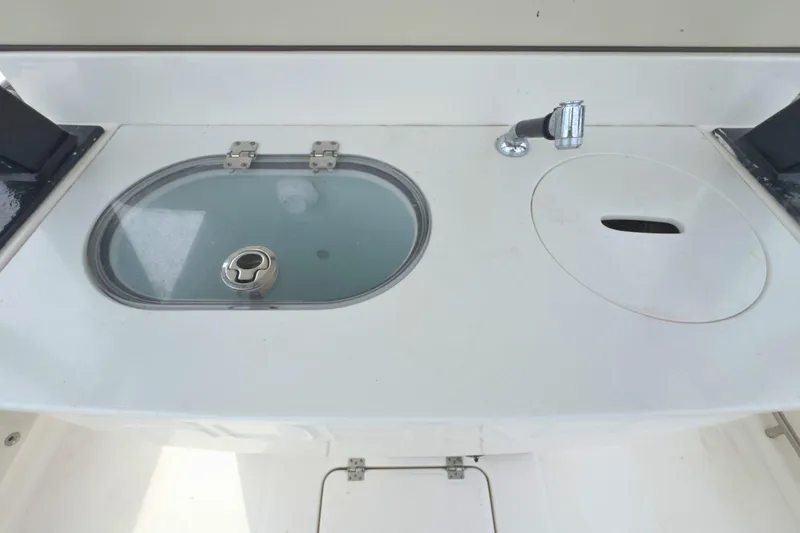 Slide: The Image of 2019 Robalo R272 Center Console boat sink and storage area. - 17