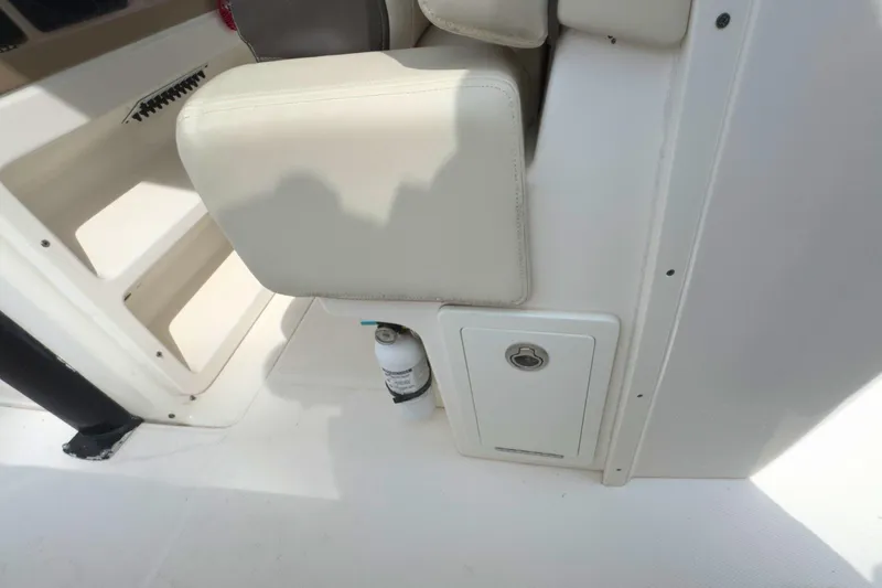 Slide: The Image of 2019 Robalo R272 Center Console interior with seat and storage compartment. - 20