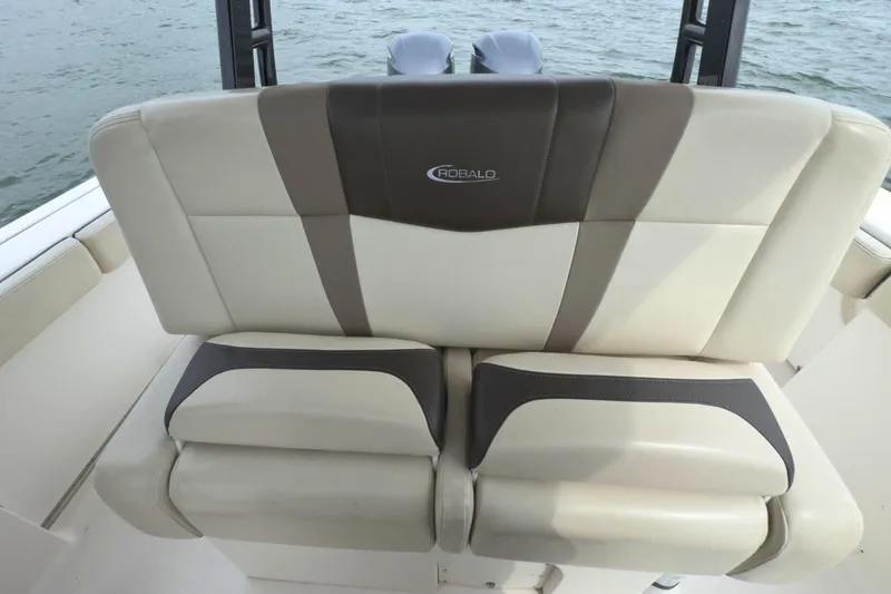 Slide: The Image of 2019 Robalo R272 Center Console boat seat, beige and brown upholstery, on water. - 21