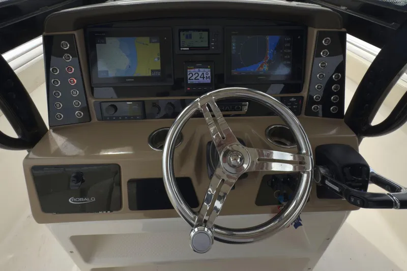 Slide: The Image of 2019 Robalo R272 Center Console dashboard with steering wheel and navigation displays. - 22