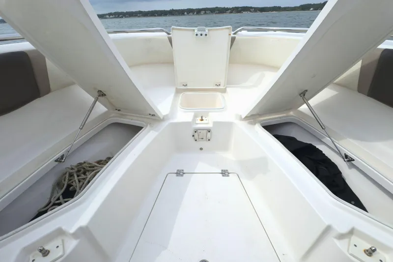 Slide: The Image of 2019 Robalo R272 Center Console boat with open storage compartments on deck. - 31