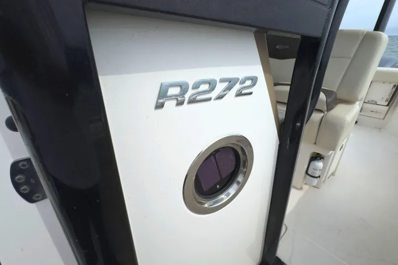 Slide: The Image of 2019 Robalo R272 Center Console interior with logo and seating detail. - 35