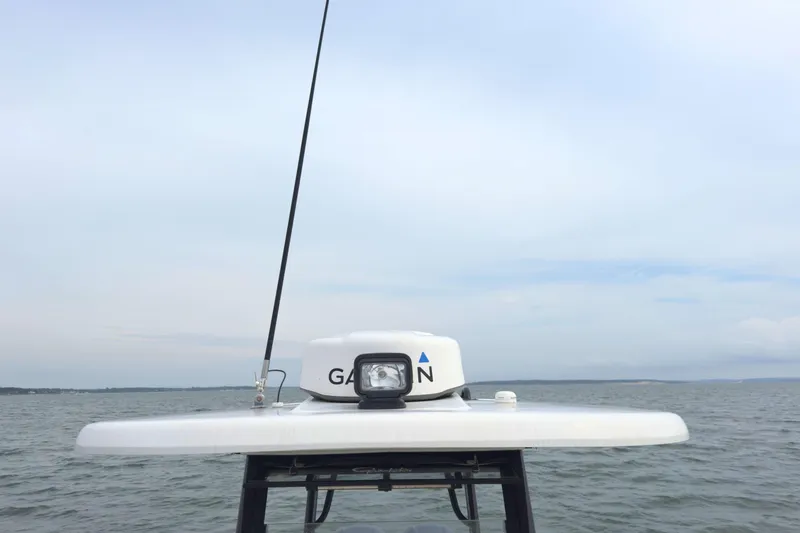 Slide: The Image of 2019 Robalo R272 Center Console boat with Garmin radar on open water. - 37