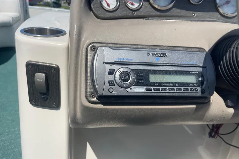 Slide: The Image of Dashboard of a 2007 Premier 231 Alante boat with gauges and compass. - 11