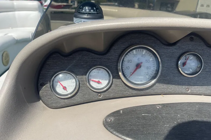 Slide: The Image of Dashboard of a 2007 Premier 231 Alante boat with gauges and controls. - 12