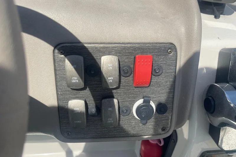 Slide: The Image of 2007 Premier 231 Alante boat dashboard with gauges and controls in sunlight. - 14