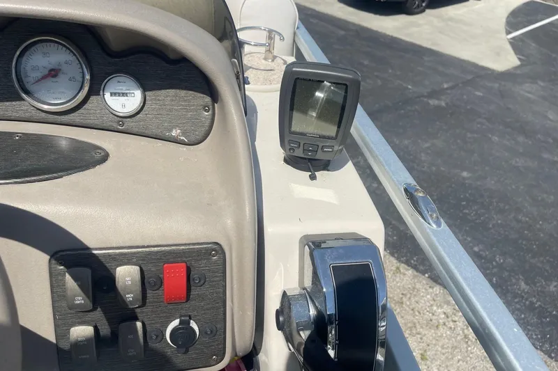 Slide: The Image of White captain's chair on 2007 Premier 231 Alante boat, featuring armrests and steering wheel. - 15