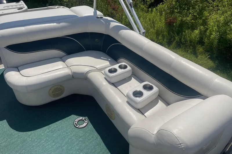 Slide: The Image of 2007 Premier 231 Alante boat with canopy and seating, docked outdoors. - 17