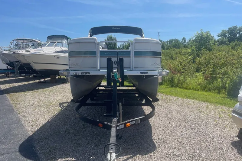 Slide: The Image of 2007 Premier 231 Alante pontoon boat on trailer, labeled "ABSOLUTLY YES," parked on gravel. - 2