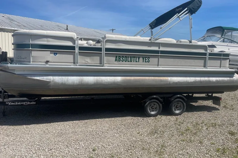 Slide: The Image of 2007 Premier 231 Alante pontoon boat with Mercury 60 outboard motor in a parking lot. - 3