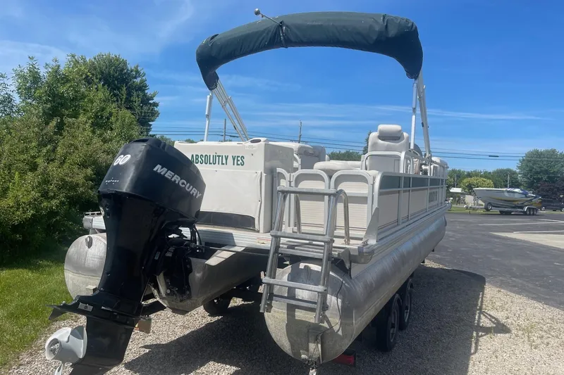 Slide: The Image of 2007 Premier 231 Alante pontoon boat with spacious seating and canopy, docked outdoors. - 5