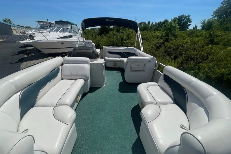 Slide: The Image of 2007 Premier 231 Alante boat interior with white seating and green carpet. - 6