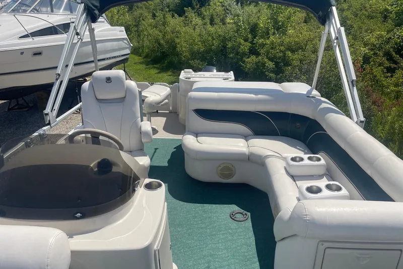 Slide: The Image of 2007 Premier 231 Alante boat interior with white seating and green carpet. - 7
