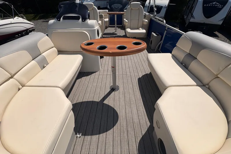 Slide: The Image of 2022 Lexington 524 boat interior with beige seating and wooden table. - 14