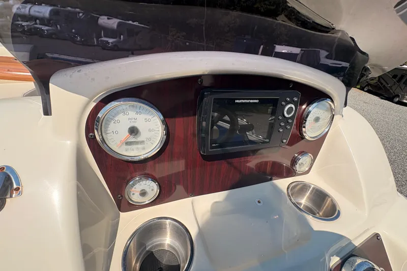 Slide: The Image of Dashboard of 2022 Lexington 524 boat with gauges and Humminbird display. - 18