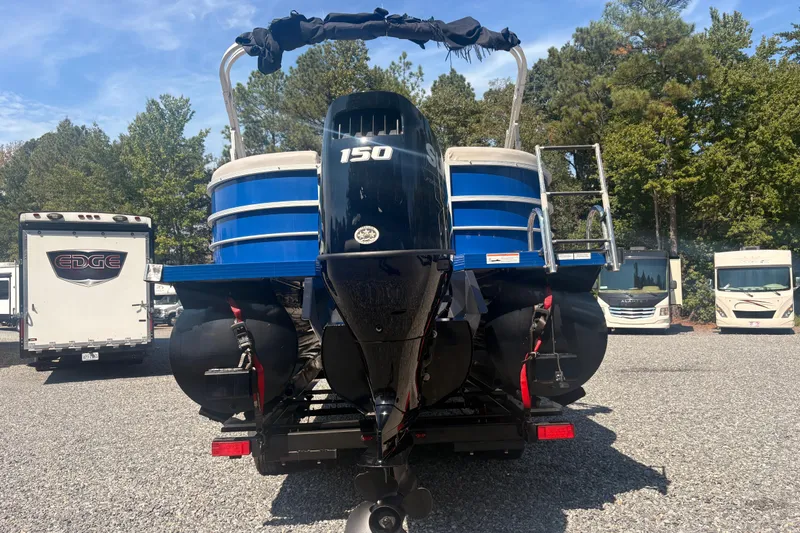 Slide: The Image of 2022 Lexington 524 boat with 150 HP engine, parked outdoors. - 3