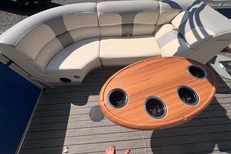 Slide: The Image of Luxurious Lexington 524 boat interior with curved seating and wooden table, 2022 model. - 8
