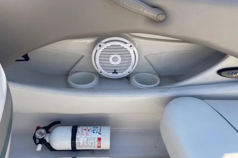 Slide: The Image of Interior of 2003 Four Winns 180 Horizon boat with speaker, cup holders, and fire extinguisher. - 10