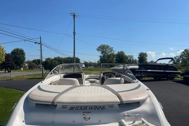 Slide: The Image of 2003 Four Winns 180 Horizon boat parked outdoors on a sunny day. - 4