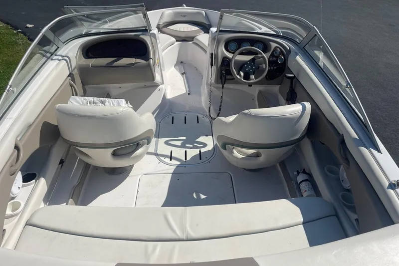Slide: The Image of 2003 Four Winns 180 Horizon boat interior with steering wheel and seating. - 6