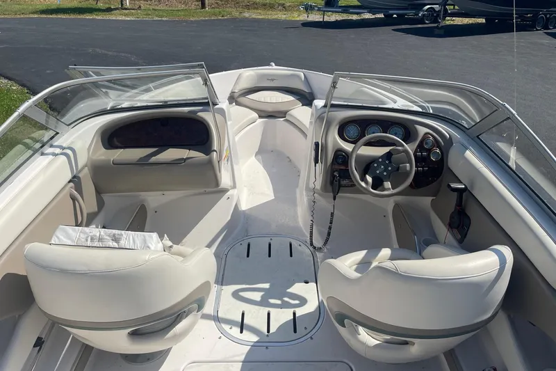 Slide: The Image of 2003 Four Winns 180 Horizon boat interior with steering wheel and seating. - 7