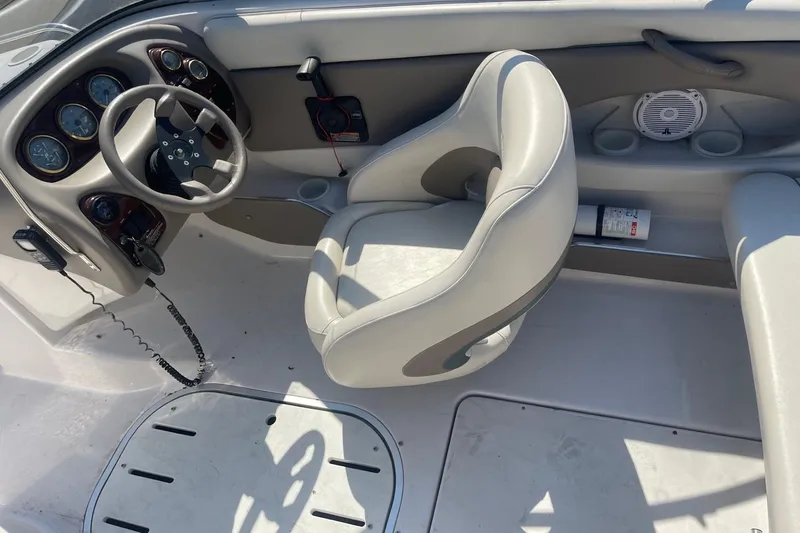 Slide: The Image of 2003 Four Winns 180 Horizon boat interior with steering wheel and dashboard controls. - 9