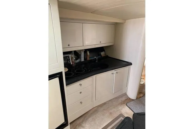 Slide: The Image of 1999 Wellcraft 45 Excalibur yacht kitchen with cabinets and countertop. - 7