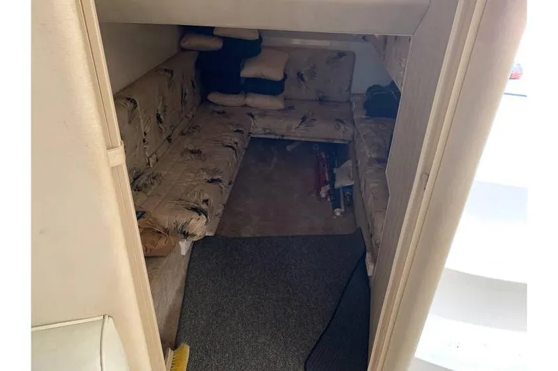 Slide: The Image of Interior cabin of 1999 Wellcraft 45 Excalibur with cushioned seating and carpeted floor. - 9