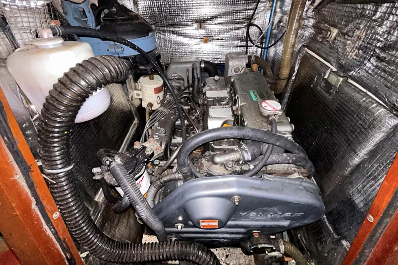 Slide: The Image of 2008 Hanse 470e sailboat covered with tarp, docked on a cloudy day. - 29