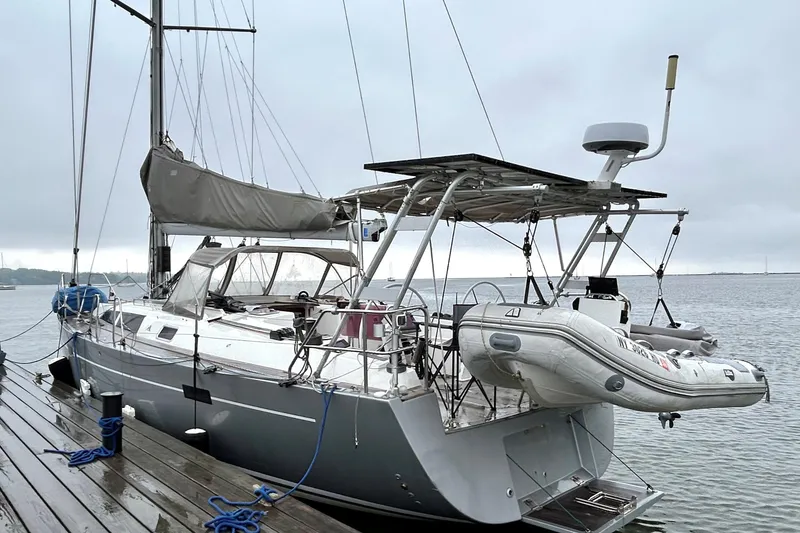 Slide: The Image of Sailing yacht Hanse 470e, 2008 model, docked with dinghy on a cloudy day. - 3