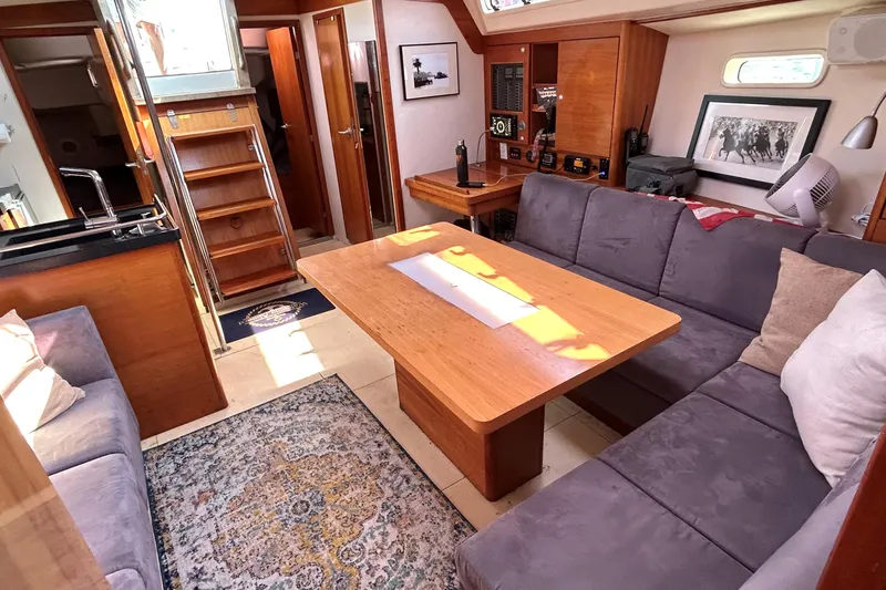 Slide: The Image of Bow of 2008 Hanse 470e sailboat with deck fittings and railing, docked by water. - 7