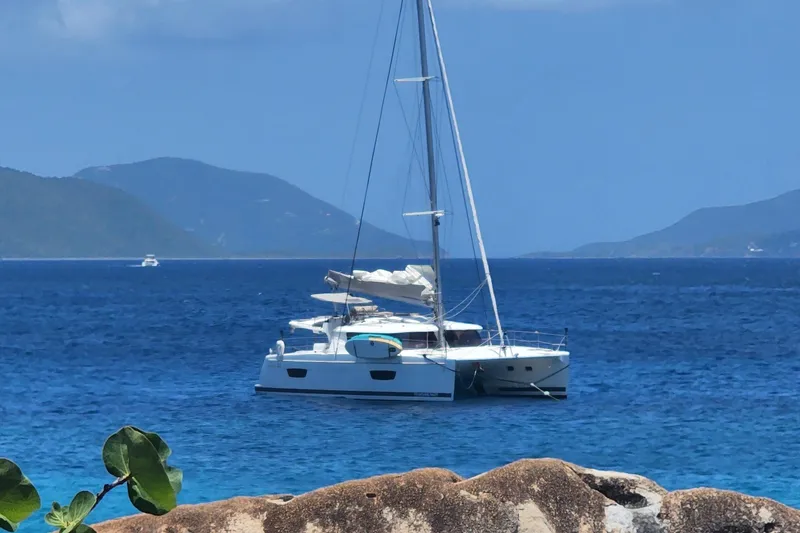 Slide: The Image of 2018 Fountaine Pajot Helia 44 Evolution catamaran sailing in clear blue waters. - 0