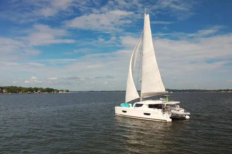 Slide: The Image of 2018 Fountaine Pajot Helia 44 Evolution sailing on a calm sea under a blue sky. - 1