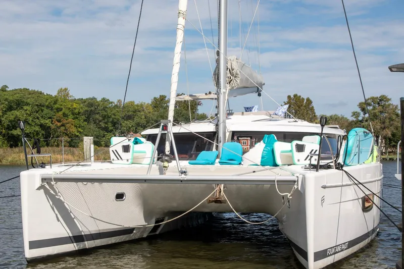 Slide: The Image of 2018 Fountaine Pajot Helia 44 Evolution catamaran docked, featuring modern design and vibrant seating. - 15