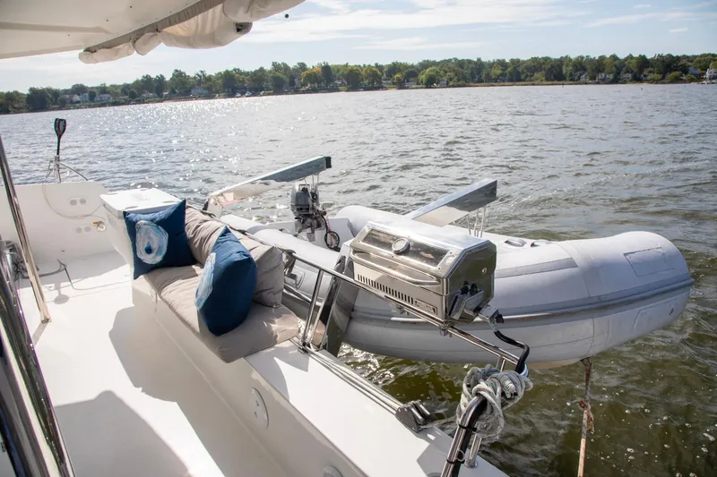 Slide: The Image of 2018 Fountaine Pajot Helia 44 Evolution yacht with dinghy and outdoor seating. - 23