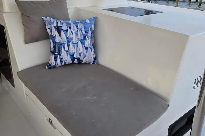 Slide: The Image of Cushioned seating area on 2018 Fountaine Pajot Helia 44 Evolution with sailboat-themed pillow. - 38