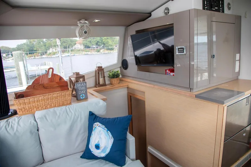 Slide: The Image of 2018 Fountaine Pajot Helia 44 Evolution interior with modern decor and scenic window view. - 48