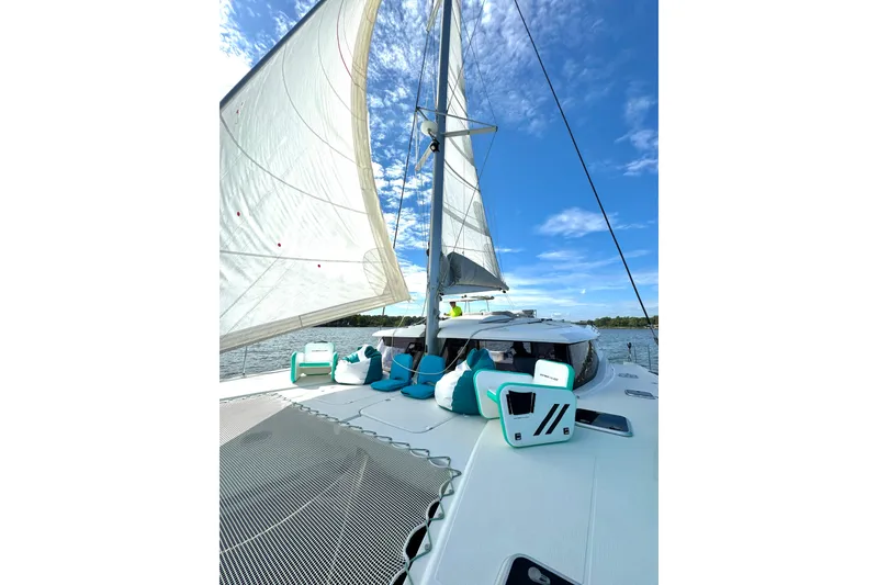 Slide: The Image of 2018 Fountaine Pajot Helia 44 Evolution sailing catamaran with open sails under a clear blue sky. - 7