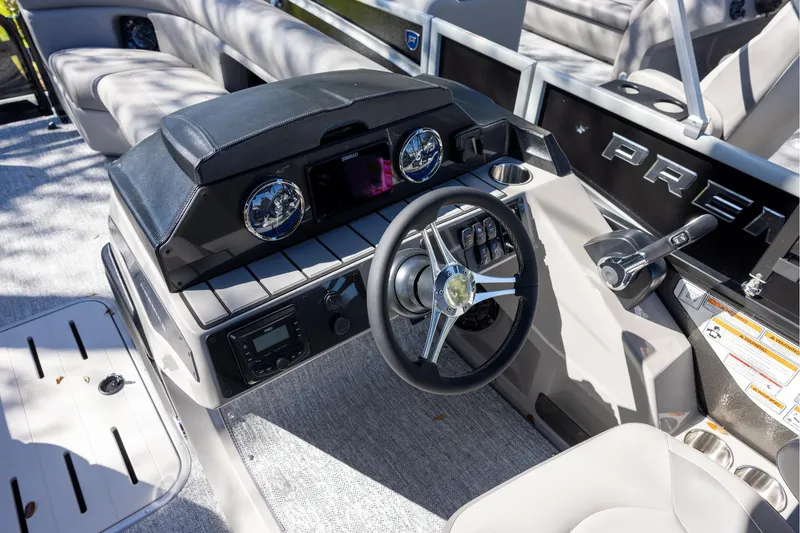 Slide: The Image of 2026 Premier 250 Sunsation RS boat dashboard with steering wheel and controls. - 10