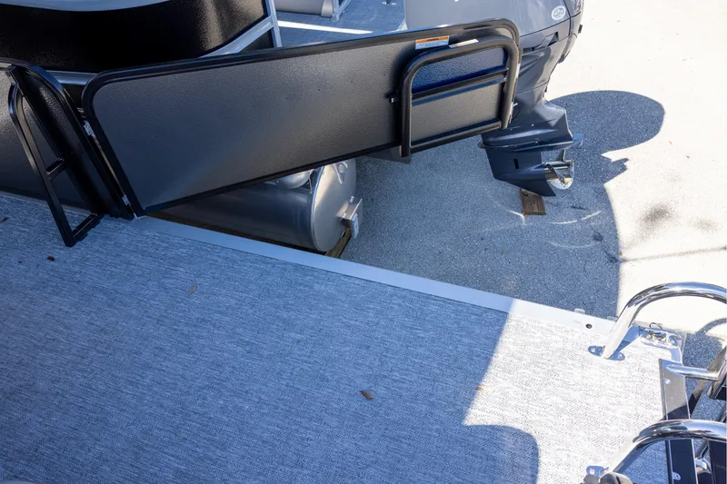 Slide: The Image of 2026 Premier 250 Sunsation RS pontoon boat with open gate and visible outboard motor. - 16