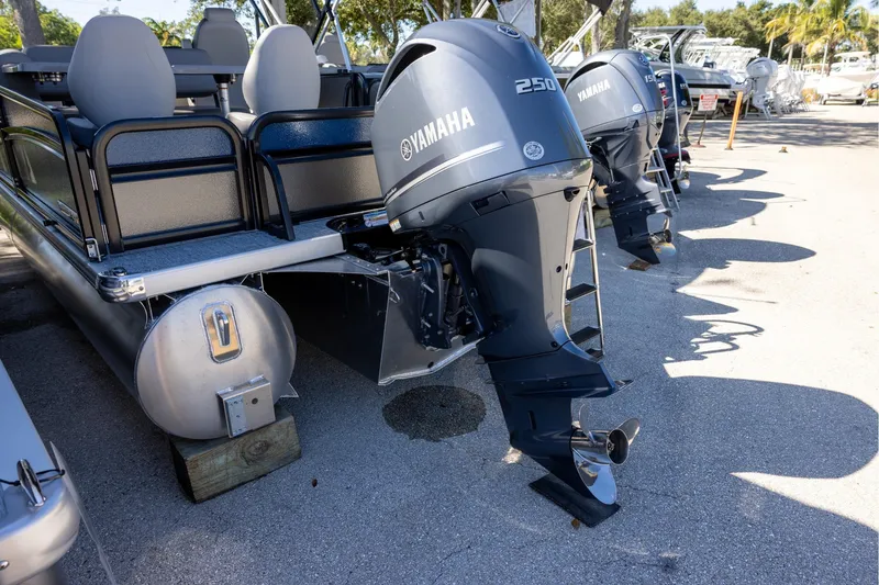 Slide: The Image of 2026 Premier 250 Sunsation RS pontoon boat with Yamaha outboard motors, parked on a sunny day. - 4