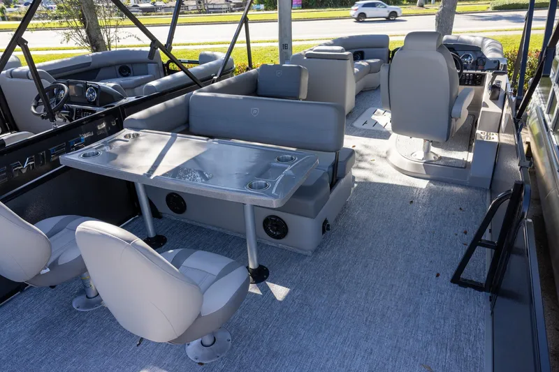 Slide: The Image of 2026 Premier 250 Sunsation RS pontoon boat interior with gray seating and table. - 5