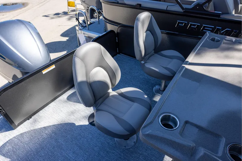 Slide: The Image of 2026 Premier 250 Sunsation RS boat interior with gray seating and table. - 6