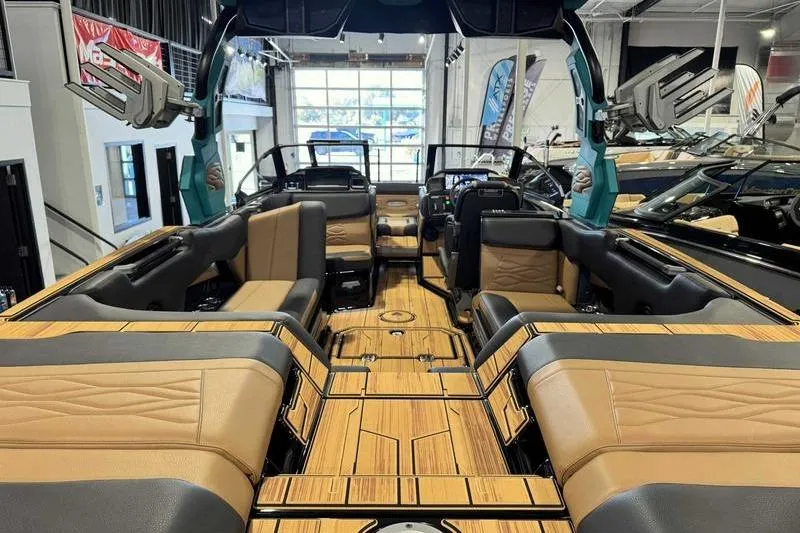 Slide: The Image of 2026 Supra SE boat interior with luxurious seating and modern design in a showroom. - 5