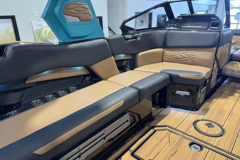 Slide: The Image of 2026 Supra SE boat interior with luxurious tan and black seating, modern design, and wood flooring. - 9