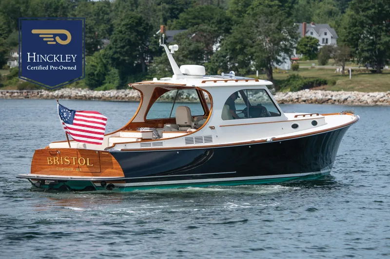 The Image of 2015 Hinckley Picnic Boat 37 MKIII cruising on water, American flag displayed, certified pre-owned. - 0