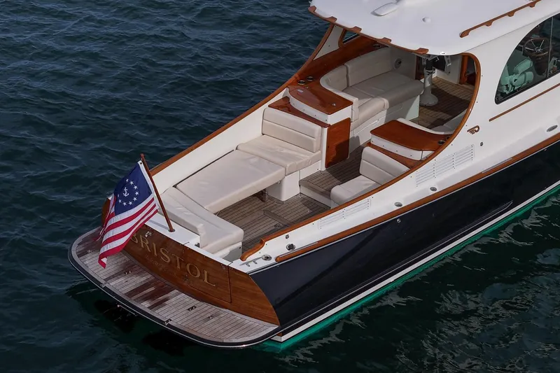 Slide: The Image of 2015 Hinckley Picnic Boat 37 MKIII on water, elegant design with American flag. - 19